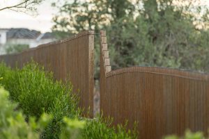 Custom rustic metal fencing around custom backyard landscape