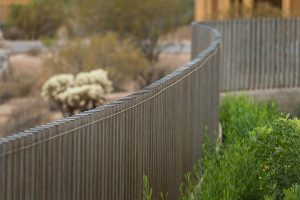 Custom rustic metal fencing around custom backyard landscape