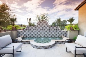 Custom front yard landscape area with Spanish fountain made of mosaic tile and desert landscape with seating area