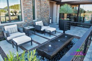 Small side patio with beautiful custom water feature with lounge area