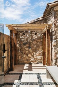Custom backyard desert landscape with side outdoor shower using wood railroad ties and stepping stone
