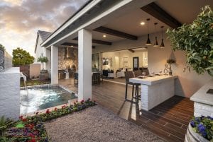 Custom outdoor landscape in Arizona backyard with small pool and water feature over firepit and outdoor dining