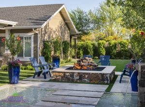 Custom outdoor landscape backyard with floating steps in pool leading up to a large firepit new home