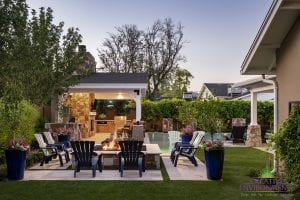 Custom outdoor landscape backyard with firepit and covered patio with seating and outdoor kitchen