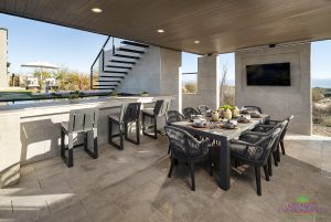 Creative Environments design and landscape at Sereno Canyon Mayne Model showing covered patio with outdoor dining and kitchen