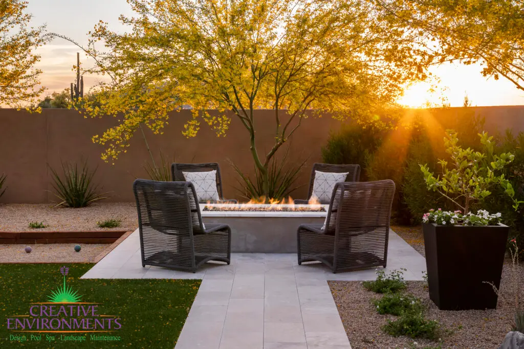 Custom backyard design with desert landscaping, fire pit and outdoor seating area.