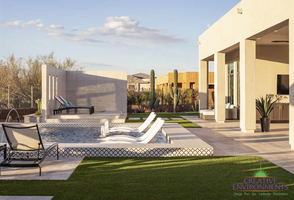 Custom backyard design with deco-tile pool, baja step and outdoor TV.