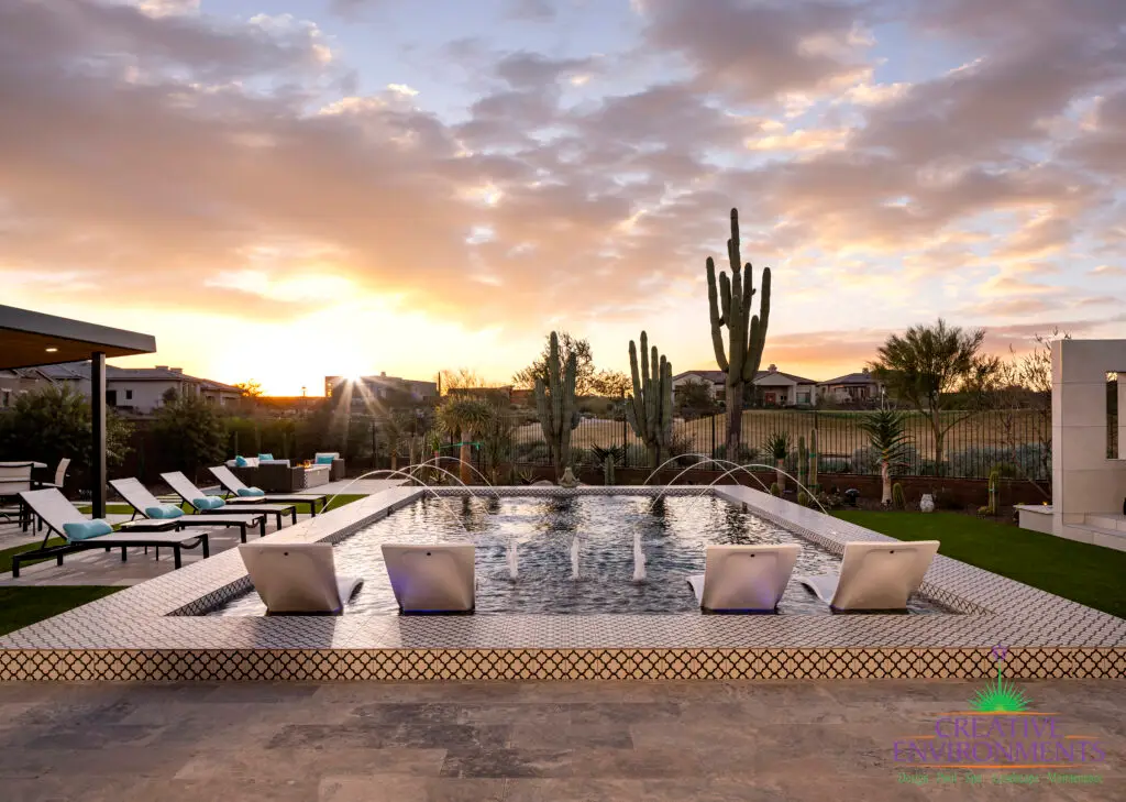 Backyard design with multiple water features in pool.