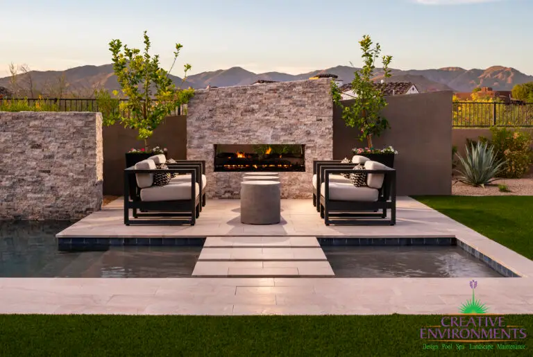 Custom backyard with Jesus steps, angled fireplace and pool.