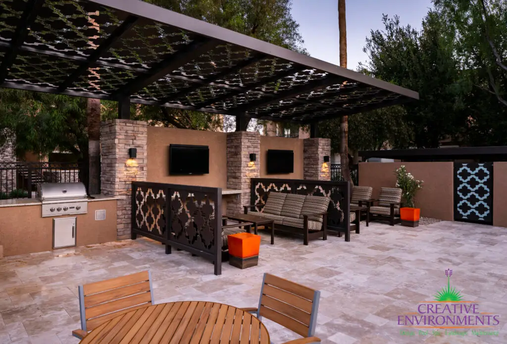 Custom community ammenities with decorative metal patterns, cantilevered shade structure and multiple outdoor seating areas.