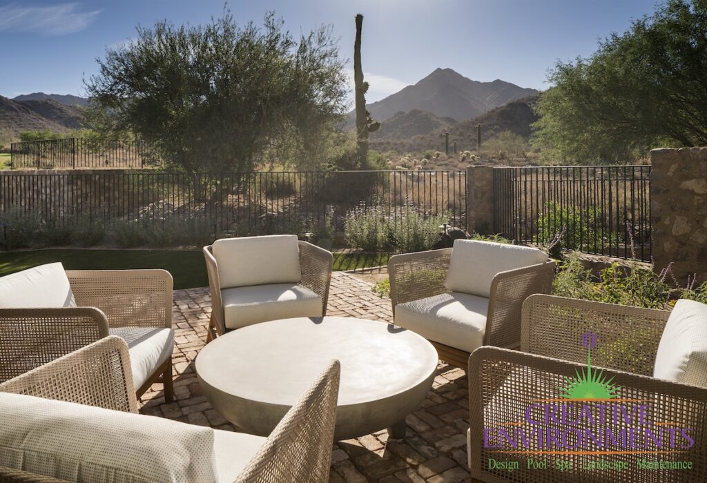 Custom backyard with multiple seating areas and desert views.