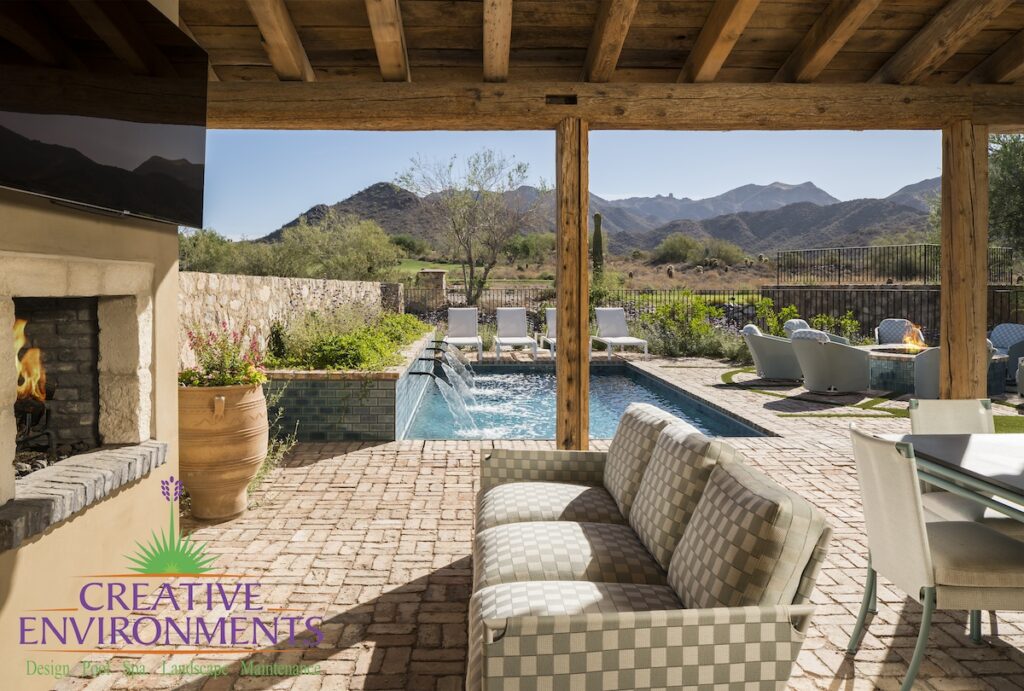 Covered patio with outdoor TV, fireplace and multiple seating areas.
