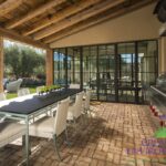 Custom indoor/outdoor fusion with outdoor dining area and pool.