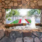 Custom community entrance with long water feature, water fountain and natural stone accents.