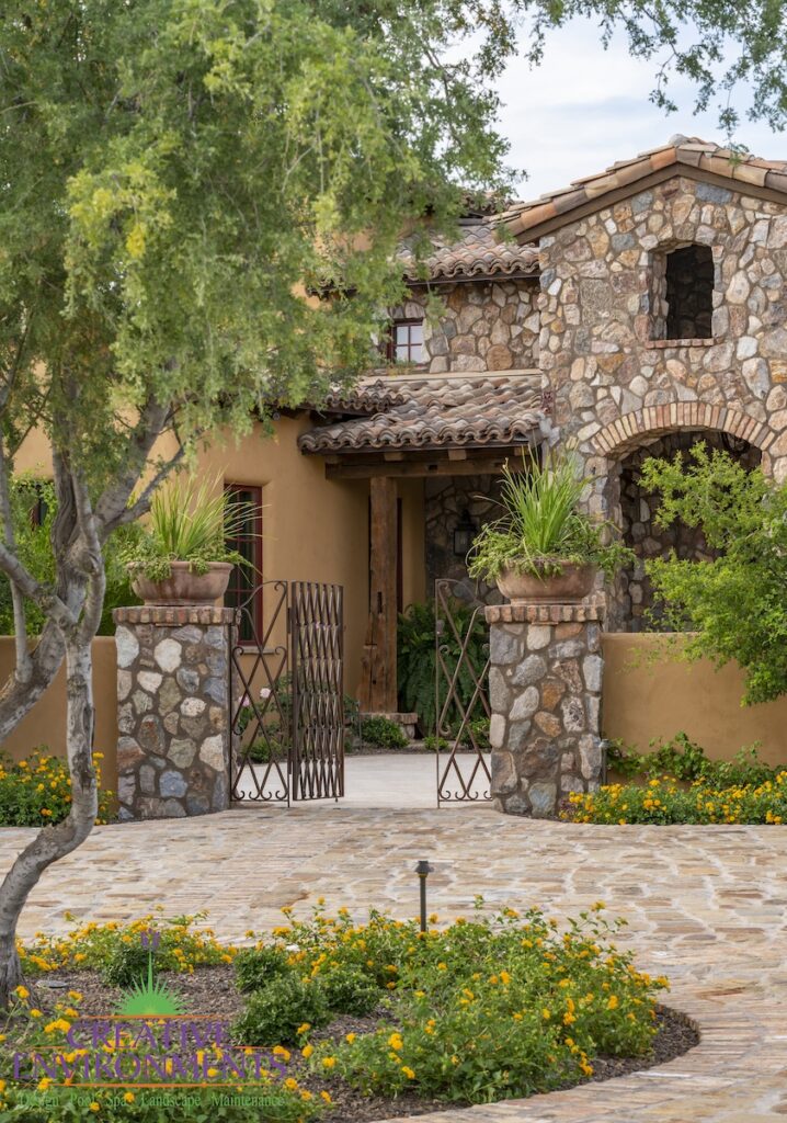 Front yard design with unique entryway and metal gate.