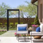 Custom backyard design with metal archway, outdoor seating area and planters.