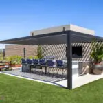 Custom backyard design with slatted metal shade structure, large planters and outdoor entertainment area.