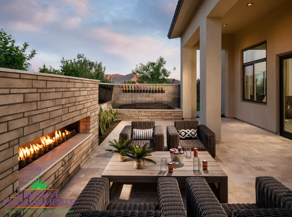 Custom backyard design with brick fireplace, beer tap water feature and outdoor seating areas.