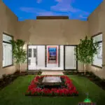 Custom courtyard design with annuals, organized planting and water feature as a focal point.