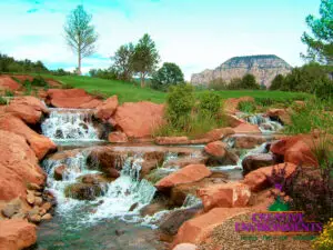 Custom natural red rock water feature with real grass.