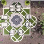 Custom backyard design with artificial turf pattern, unique-shaped fire pit and outdoor seating area.