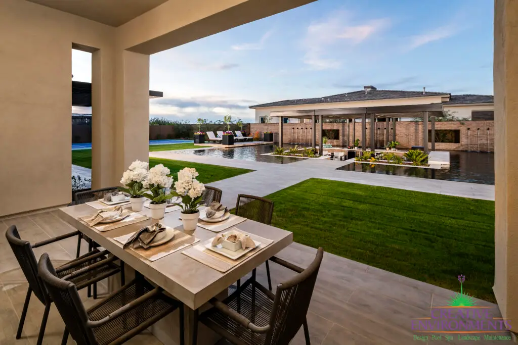 Backyard design with real grass and outdoor dining area.