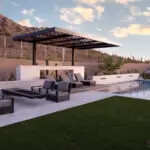 Custom backyard design with cantilevered metal shade structure, cantilevered fire table and artificial turf.