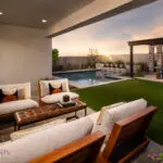 Custom backyard design with multiple seating areas, outdoor entertainment area and pool.