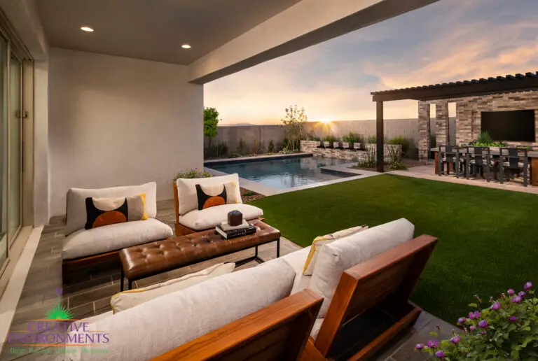 Custom backyard design with multiple seating areas, outdoor entertainment area and pool.