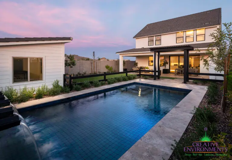 Backyard design with custom trellis and pool with water feature