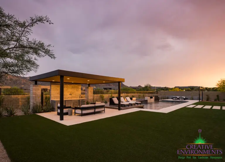 Backyard design with shade structure and artificial turf.