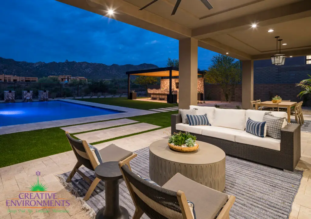 Custom backyard design with multiple seating areas, recessed lighting and outdoor fan.