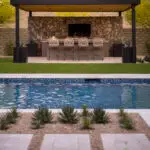 Custom backyard design with blue pool, angled shade structure and large metal planters.