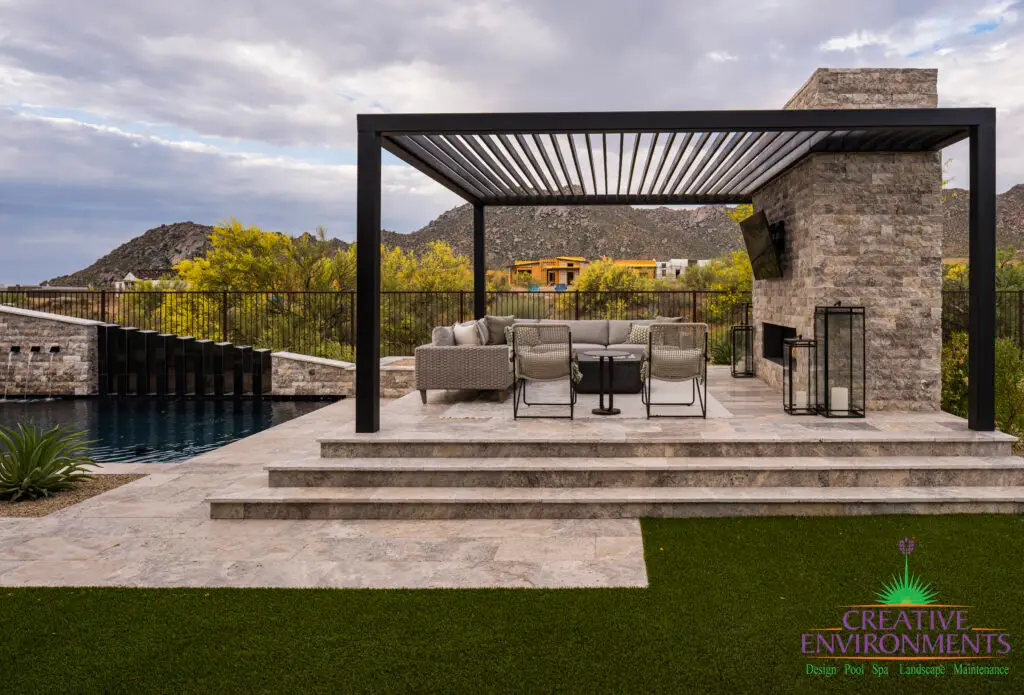 Custom backyard design with slatted shade structure, raised outdoor seating area and artificial turf.