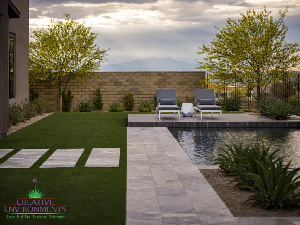 Custom backyard design desert landscape design, artificial turf and natural stone steps.