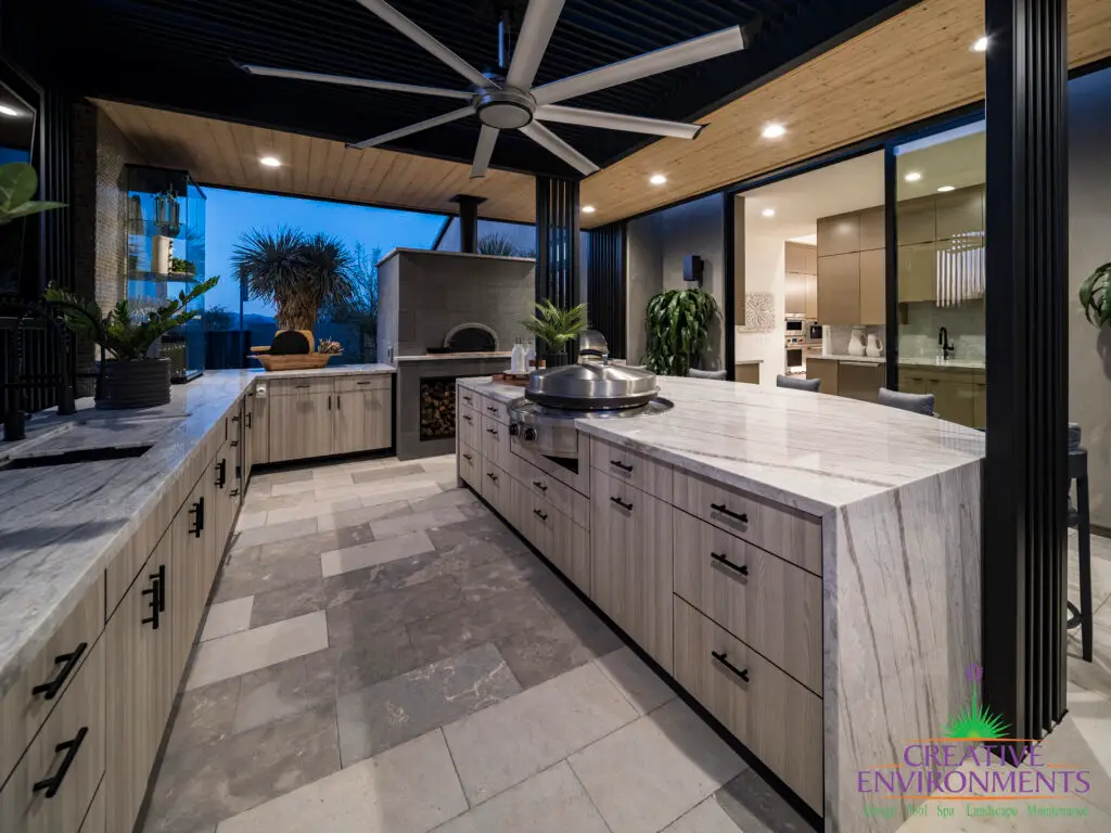 Backyard design with marble-inspired counters, outdoor fan and pizza oven.