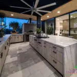 Backyard design with marble-inspired counters, outdoor fan and pizza oven.