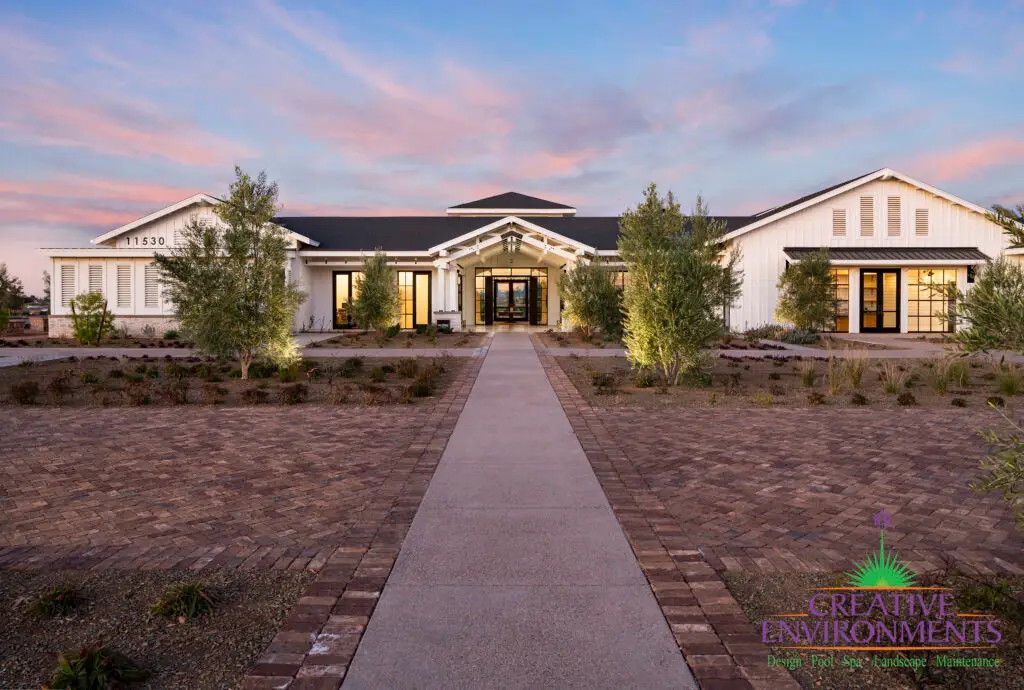 Custom community amenities with clubhouse, organized planting and uplighting.