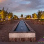 Custom community amenities with water feature, large brick planters and uplighting.