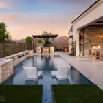 Custom backyard design with baja step, metal water scuppers and Spanish design style