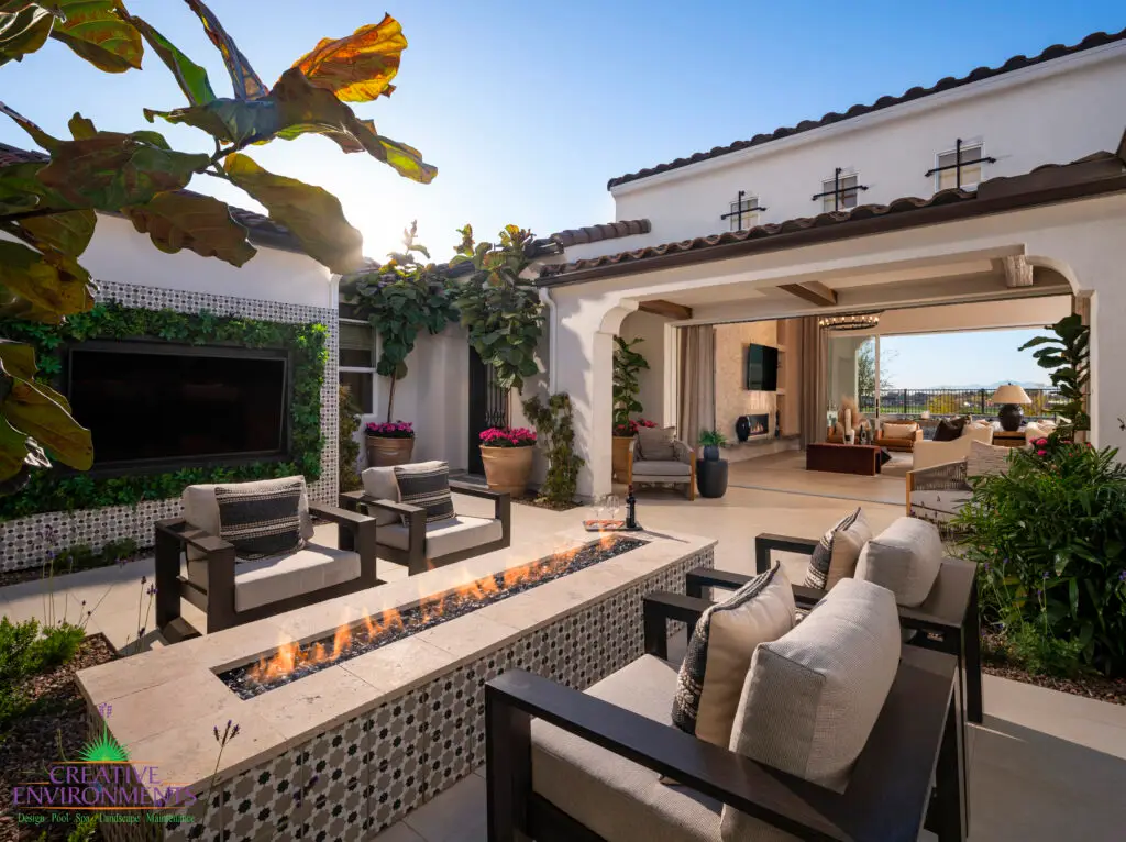 Custom backyard design with living wall, outdoor TV and deco-tile linear fire pit.