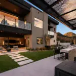 Custom backyard design with cantilevered shade structure, artificial turf and multiple seating areas