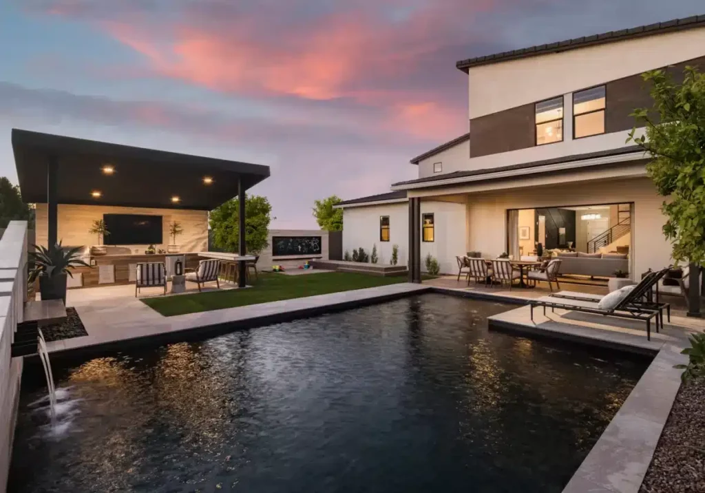 Backyard design with artificial turf, angled shade structure and metal planters.