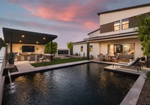 Backyard design with artificial turf, angled shade structure and metal planters.