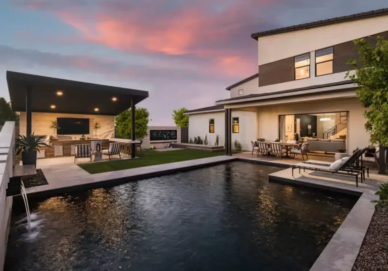 Backyard design with artificial turf, angled shade structure and metal planters.