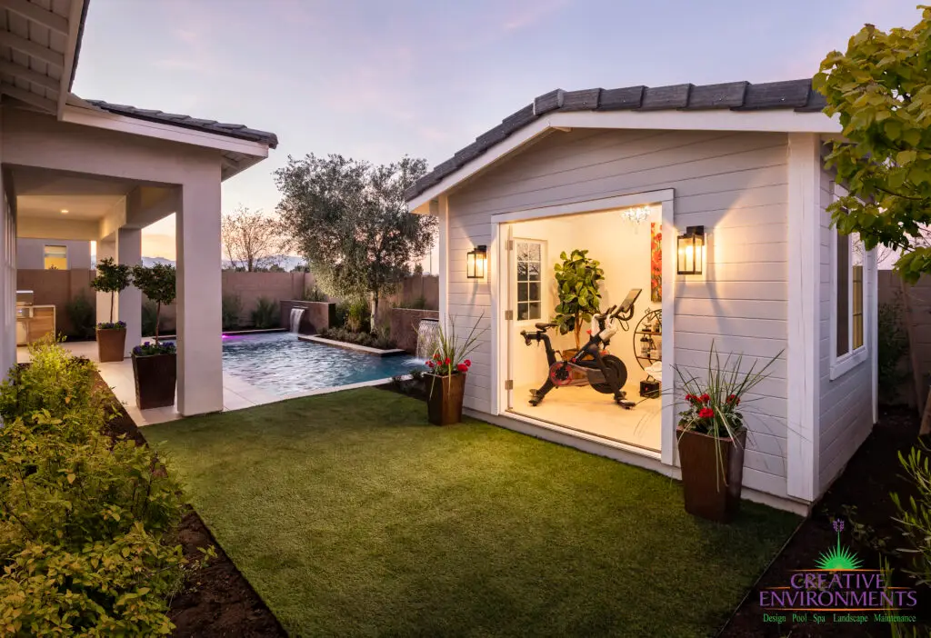 Custom backyard design with outdoor gym, pool and large metal planters.