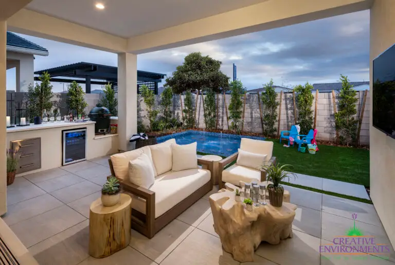 Backyard design with kid's pool and outdoor kitchen.