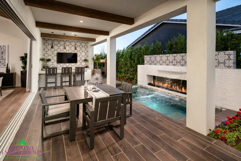 Custom backyard design with deco-tile backsplash, bar seating and outdoor dining area.