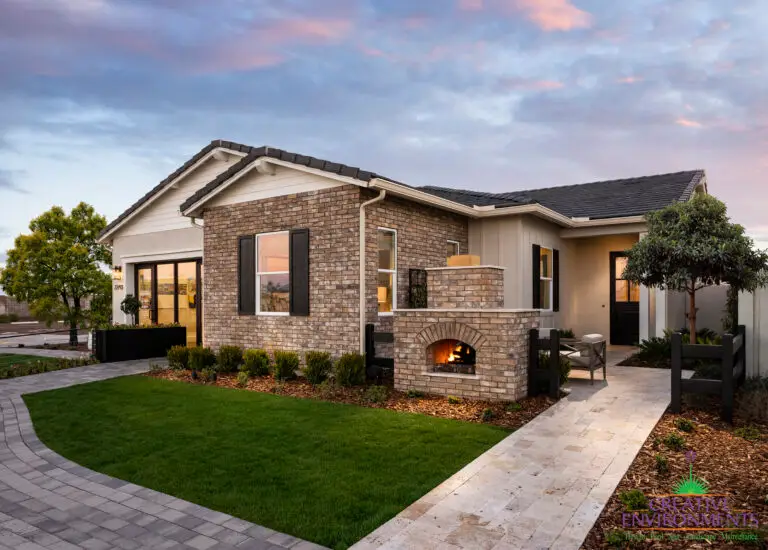 Front yard design with entryway fireplace and pavers.