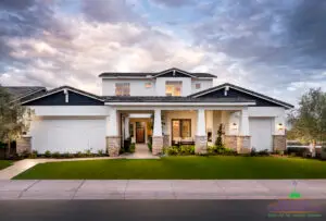 Custom front yard design with artificial turf, tree lighting and organized planting.